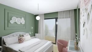 ein Schlafzimmer mit einem weißen Bett und einem rosa Stuhl in der Unterkunft Apartament Margaret in Oppeln