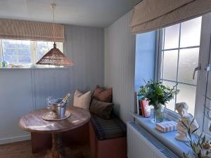 a room with a small table and a window at Boutique Cottage in the Heart of Kintbury in Kintbury