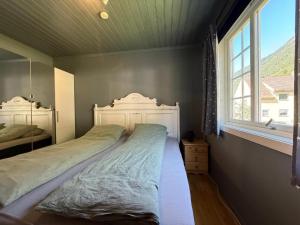 a bedroom with a bed and a window at Tveitopark Apartments NO 2 in Øverland