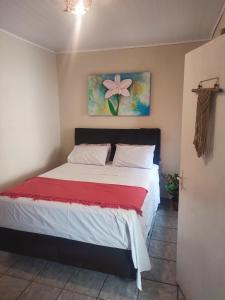 a bedroom with a bed with a red blanket at Colonial House in Porto Seguro +13 photos