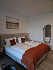 a bedroom with a large bed with a tv on the wall at Olymp 1-4 in Bamberg +67 photos