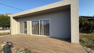 a building with a large garage with a wooden deck at Elias house in Tríkala