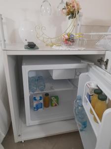 an open refrigerator filled with lots of food and drinks at Falanga Family Guests Accommodation in Civitavecchia +24 photos