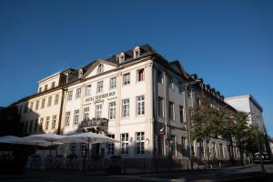 a large white building on the corner of a street at Hotel Trierer Hof in Koblenz +35 photos