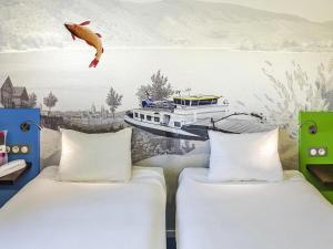 Postel nebo postele na pokoji v ubytování ibis Styles Strasbourg Avenue du Rhin