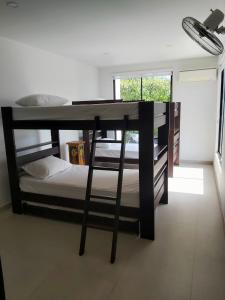 a room with a bunk bed and a desk at Exclusiva casa campestre in Ricaurte