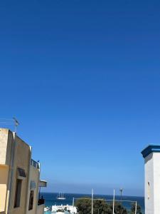 a view of the ocean from a building at Appartement Neuf Plage Mdiq in M'diq