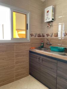 a kitchen with a sink and a window at Appartement Neuf Plage Mdiq in M'diq