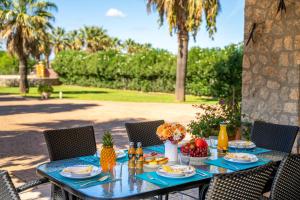a blue table with fruit on it with chairs at Ideal Property Mallorca - Son Manyo 223 in Sa Pobla