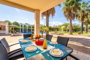 a table with a blue table cloth on a patio at Ideal Property Mallorca - Son Manyo 223 in Sa Pobla