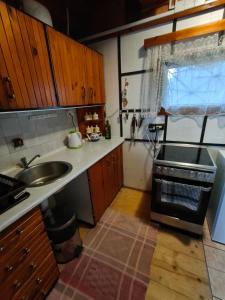 a kitchen with a sink and a stove at Chata Tatranec in Poráč +23 photos