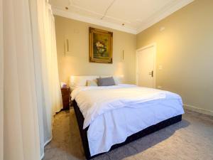 a bedroom with a bed with a picture on the wall at Champollion Khan in Cairo
