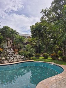 a swimming pool in the yard of a house at ALONALAND RESORT in Panglao Island