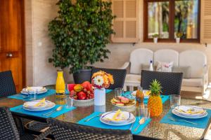 a table with fruits and plates of food on it at Ideal Property Mallorca - Son Manyo 223 in Sa Pobla