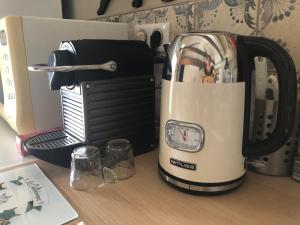 a toaster sitting on top of a table next to a toaster at Maisonnette de charme Les Jardins de Lou in Boussac