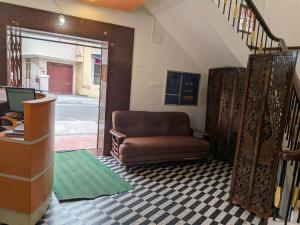 a living room with a couch and a desk at CM Residency in Salem