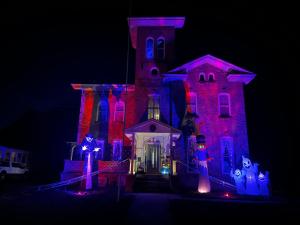 a house that is lit up up for halloween at Graystone Manor in Albion