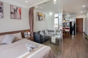 a bedroom with a bed and a glass wall at La Passion - Tay Ho Hanoi One Bedroom Apartment! in Hanoi