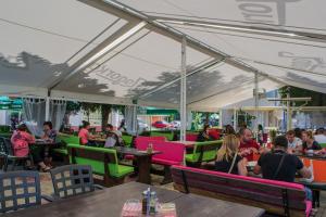 a group of people sitting at tables in a restaurant at Central Guest Rooms in Asenovgrad