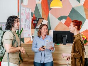 a group of three people standing around a counter at Aparthotel Adagio Access Nancy Centre in Nancy