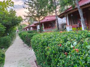 a path in front of a house with bushes at Gate way resort in Purbbadulki