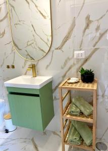 a bathroom with a green vanity and a mirror at Dimora San Mario in Portici +15 photos