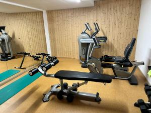 a gym with three exercise bikes in a room at Seesicht - Rückzugsort mit Sauna und Freizeitlounge in Wienacht-Tobel