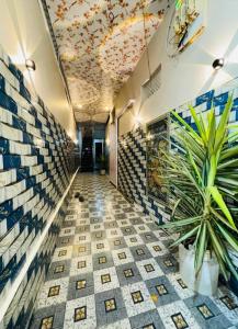 a hallway with a tile floor and a ceiling at Sheetal palce hotel in Ujjain