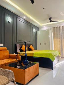 a bedroom with a bed and a couch at Modern peaceful private property in Noida