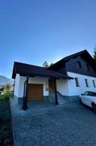 a house with a car parked in front of it at Apartment Rossleithen 