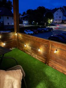 a balcony with green grass and lights on it at Adriany apartmán in Bayerisch Eisenstein
