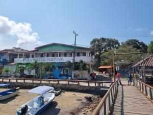 a group of boats sitting on the sand near a dock at Pousada Nativa - Vista ao mar in Ilha de Boipeba