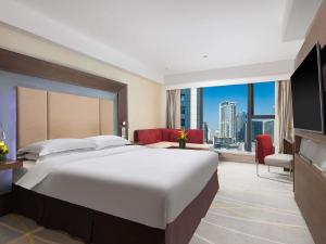 a bedroom with a large bed and a large window at Novotel Nanjing Central in Nanjing