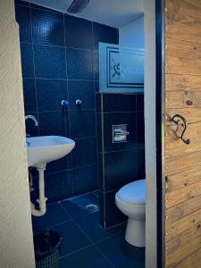 a bathroom with a toilet and a sink at Vicalis Hotel, Villas y Glamping in San Sebastian Xolalpa +77 photos