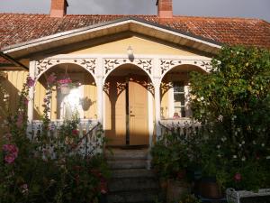 a house with a white gate and a porch at Elsasgården - Rum för lugn in Mörbylånga +11 photos