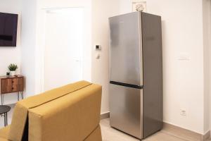 a stainless steel refrigerator in a room with a box at in Central Sesvete One in Sesvete