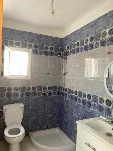 a bathroom with a toilet and a sink at maison ridene in Kelibia