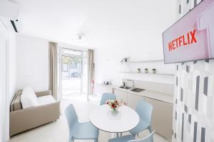 a dining room with a white table and chairs at Residence Le Sirene in Termoli +11 photos