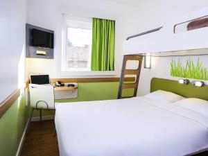 ein Schlafzimmer mit einem Bett und einem Schreibtisch mit einem Computer in der Unterkunft ibis budget Campo Grande in Campo Grande + 25 Fotos