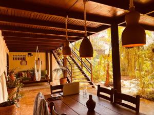 a living room with a wooden table and pendant lights at Villa Valencia in Jericoacoara