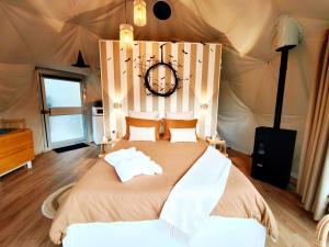 a bedroom with a bed in a tent at Dôme Saint-Eloi in Floursies
