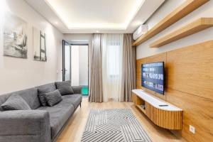 a living room with a couch and a tv at Chido Residence in Istanbul