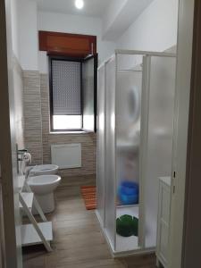 a bathroom with a shower with a toilet and a sink at La Rotonda in Diamante