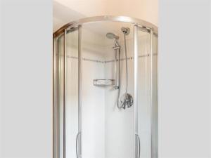 a shower with a glass door in a bathroom at Happy Sea Home - monolocale sul mare in Albinia