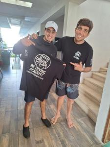 two men wearing black shirts standing next to each other at Be Diving House in Cozumel