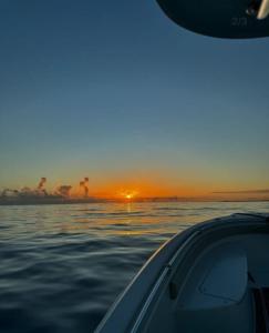 a view of the sunset from a boat in the water at V3 Pr Rentals Walk To The Beach 7 Min in San Juan