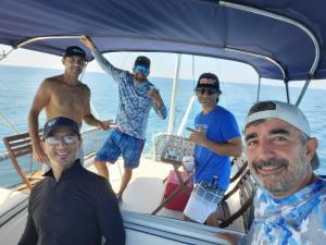 a group of people standing on the back of a boat at V3 Pr Rentals Walk To The Beach 7 Min in San Juan