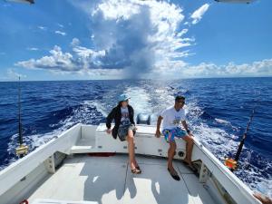 two people sitting on the back of a boat in the ocean at Pr Rentals Expectacular Location in San Juan