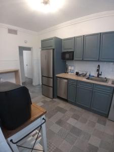 a kitchen with blue cabinets and a sink at Pr Rentals Expectacular Location in San Juan +57 photos