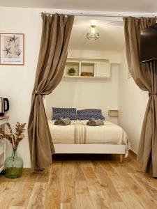 a bedroom with a bed with curtains in it at Le Nid Marin in Ault